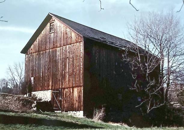 This is the photograph of the weathered barn with a laid stone foundation in a field in Warwick that Steven Carras took while on a drive with a friend when they were in their late teens. “We had ventured north from suburban New Jersey one day on a sort of photographic safari and ended up in Orange County. The back of the photo says simply: near Warwick, NY. I spent many years traveling around the Warwick area hoping to see that barn again - without success,” Carras wrote.