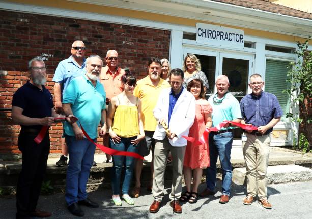 Photo by Roger Gavan On Friday, June 28, Town of Warwick Supervisor Michael Sweeton (far right), Mayor Michael Newhard (far left) and members of the Warwick Valley Chamber of Commerce joined Dr. Erik Krebs (center) and his family for the official grand opening of Warwick Family Chiropractic.