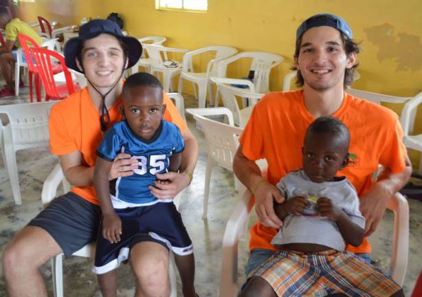 From left, James Juliano and Andrew Juliano with children from the Haitian village, Munoz.