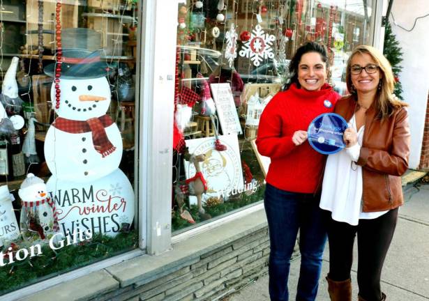“This year exceeded last year in sales,” said Nicole Repose (right), owner of Etched in Time Engraving, posing with her Store Manager Zahra Khorsand (left) while holding a Shop Small promotional sign.