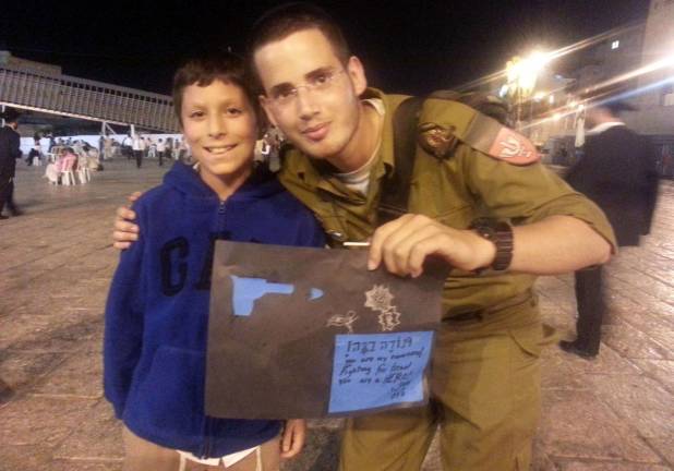 Good deeds, near and far Duvy Burston, 10, of Monroe, gives a card to an Israeli soldier in Jerusalem. The card was made by Talia Justin of Middletown, in Chabadís Camp Gan Israel. The card reads: ìTodah Rabah! (Thank you!) You are my super hero! Fighting for Israel you are a HERO! From, Talia.î