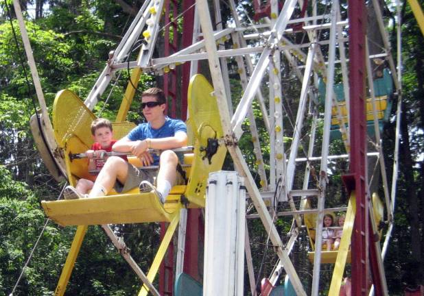 St. Stephen’s Parish bazaar held May 30 - June 2 Photos by Roger Gavan Kevin Connolly, 8, enjoys a ride on the Ferris Wheel with his older brother Thomas, 16.