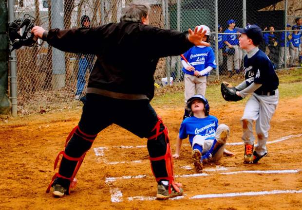 Play ball A Blanket Boss player looks up at the umpire after stealimg home.
