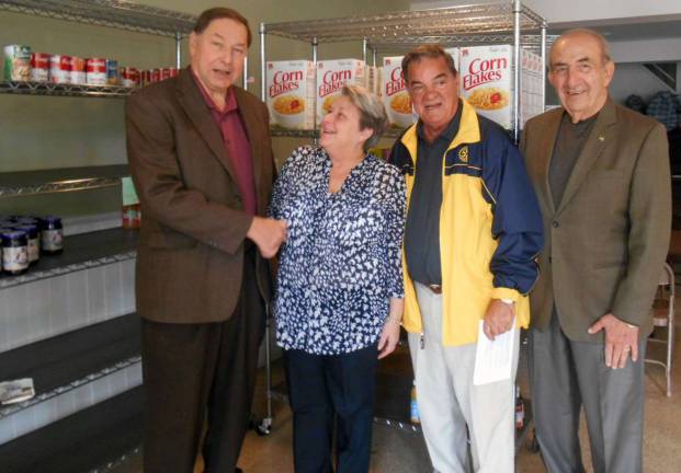 Defining community service Photo by Eileen Purcell Florida Mayor Jim Pawliczek congratulates Denise Thibault, who has volunteered as director of the Florida Food Pantry at the Florida Presbyterian Church in the Village of Florida for more than 10 years. She will receive an Outstanding Community Service Award during the Warwick Citizen of the Year celebration Oct. 23 honoring Dr. Richard Hull. Warwick Rotarians Stan Martin and Leo Kaytes are co-chairs for the event.