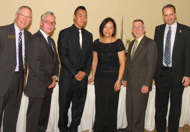 Warwick Valley Chamber of Commerce hosts its 74th annual membership dinner A þÄúBest Building RenovationþÄù award was presented to GþÄôs Restaurant co-owner Joann Kim. From left, Executive Director Michael Johndrow,Mayor Michael Newhard, Kim's son Andrew, Joann Kim, Town of Warwick Supervisor Michael Sweeton and Chamber President Paul Rafanello.