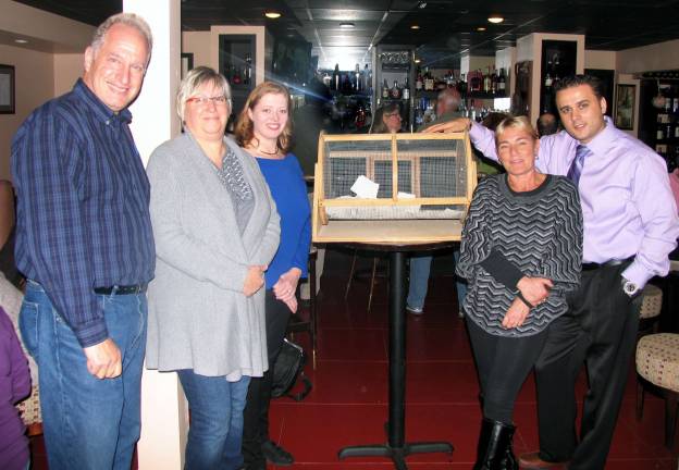 Holiday raffle raises $3,760 Photo by Roger Gavan On Sunday, Nov. 18, a drawing was held at Grappa Ristorante on Railroad Avenue to select the winners of the 2012 Backpack Snack Attack Holiday Raffle. From left, Backpack Snack Attack volunteers Len Singer, Mary Schweitzer, Laura Nokland, Adele Singer and Tony Sylaj, owner of Grappa Ristorante.