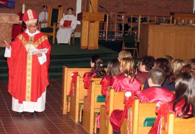 'Be sealed with the gift of the Holy Spirit' Before administering the Sacrament, Bishop Lagonegro, the Auxiliary Bishop of the Archdiocese of New York, poke about the community service that each of the candidates had performed.