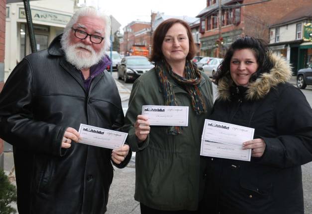 Merchant gift certificates can be a last minute solution for Christmas Photo by Roger Gavan From left, Merchant Guild President Tom Roberts, owner of Ye Olde Warwick Book Shoppe, Newhard’s co-owner Beth Newhard and Home for the Holidays co-chair Corrine Iurato, manager of Peck’s Wines and Spirits. Home for the Holidays co-chair Mary Beth Schlichting, owner of Frazzleberries, was not available for the photo.