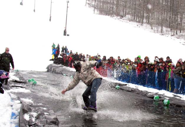 Mt. Peter holds Spring Rally and Wacky Water Skiing Contest Keith Powell looking good on his snow - er - water board.