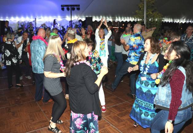 Although there were rain showers from time to time, guests were able to stay dry under the tent and spend more time socializing and dancing to the music of the popular Cloudnyne band.