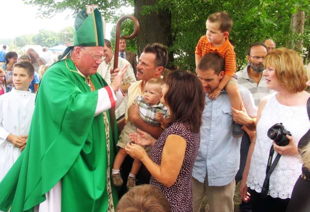 Blessed are the ball players and the gardeners After blessing the fields and the garden, Cardinal Timotny Dolan paused to speak with and posed for photographs although it was an extremely warm day.