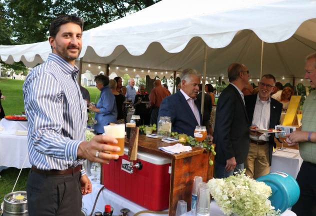 Celebrating Warwick's history Daniel Sarno serves a craft beer from Pine Island Brewery.
