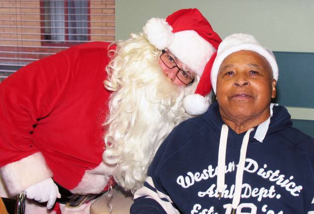 Schervier Pavilion hosts Christmas party Santa visits with resident Winston Williams.