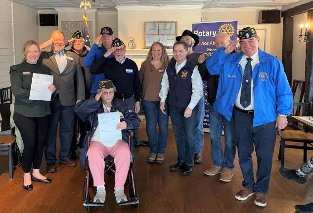 Jennifer DeFrancesco, executive director of Hudson Valley Honor Flight with (standing l-r) veterans Ed Lynch, Mike Eckert, Tom Brennan, Tony Cosimano, Warwick Rotary president Laura Barca, Candido Rivera, John McDonald, Everist Lemay and Stan Martin. Rose Becker is seated in front.