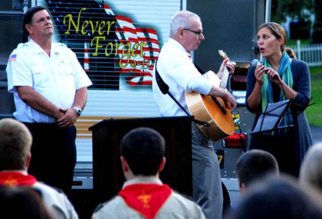 Warwick's eleventh 9-11 anniversary ceremony held in Veterans Memorial Park Photo by Ed Bailey Larry Newcomb and Leigh Jonaitis led the singing of the Star Spangled Banner and "God Bless America" during the services in Greenwood Lake Tuesday evening that marked the 11th anniversary of the terrorist attacks on the United States.