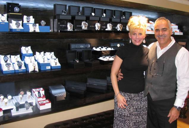 Forever Jewelers expands wristwatch collection with new custom display case Photo by Roger Gavan Posing alongside the new wristwatch display case at Forever Jewelers are store manager Catherine De Mercado and co-owner Moshe Schwartzberg.