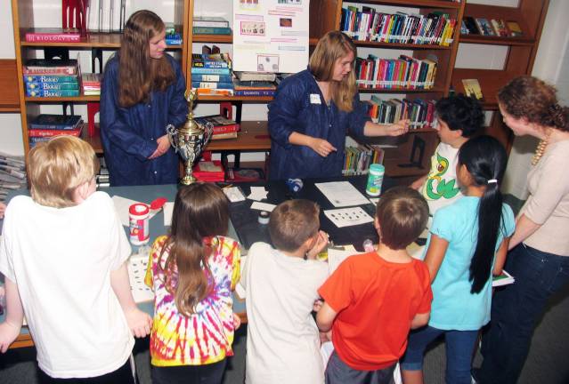 Warwick High School students help Sanfordville students appreciate chemistry Photo by Roger Gavan Kathryn Ranni and Christina Carmody demonstrate the importance of finger printing. Additional photos can be found online at warwickadvertiser.com.