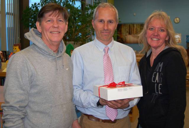 Apples of their students' eyes Noble Pies co-owners Leslie Noble and Tom Herman flank Sanfordville Elementary School teacher Robert Kirschke. “He takes the kids outside to learn science and math by measuring trees and finding leaves so that the kids don’t even know they are doing science and math according to the standards set by the state,” a parent of one of his students wrote.