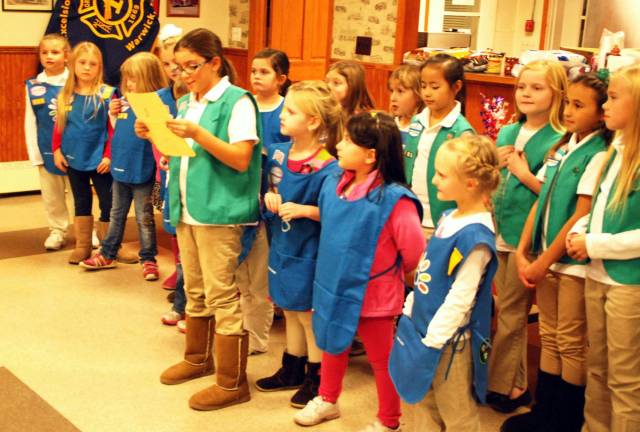 From young to old: Thanks Lauren Casale reads a prayer before the meal is served.