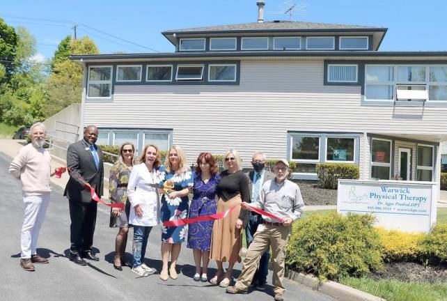 On Friday, May 14, Town of Warwick Supervisor Michael Sweeton(right), Mayor Michael Newhard,(left) members of the Warwick Valley Chamber of Commerce and Leon Dixon of TD Bank (2nd from left) joined owner Dr. Agnieszka Pindral (center) and her staff to celebrate the grand opening of Warwick Physical Therapy’s expanded location. Photo by Roger Gavan.