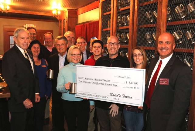 Baird's Tavern donates $5,125 to Warwick Historical Society Photo by Roger Gavan Baird's Tavern owners Adam Powers and Johnny Barounis recently welcomed Warwick Valley Chamber of Commerce and Warwick Historical Society members for an after hours mixer. During the evening Powers and General Manager Sarah Colley (center holding symbolic check) presented Warwick Historical Society board members with a check for $5,125 donated from sales of their tavern mug memberships.