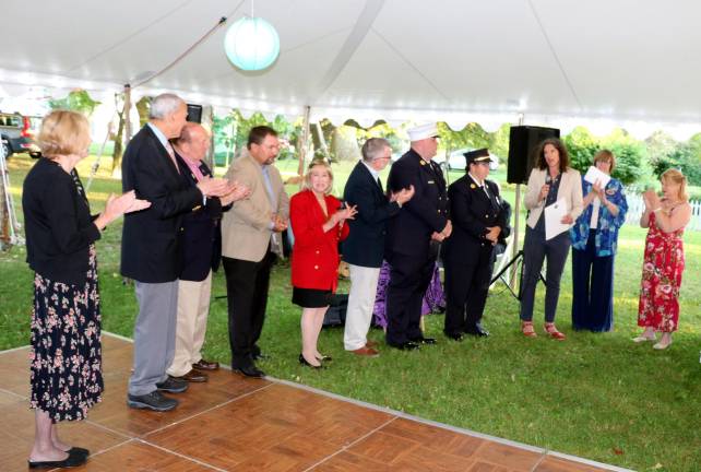 During the evening, Mary Ann Knight (2nd from right), president of the Historical Society, and Executive Director Nora Gurich (far right) welcomed guests, local officials and New York Senator Jen Metzger (third from right), who presented a State Senate Award to the Warwick Fire District.