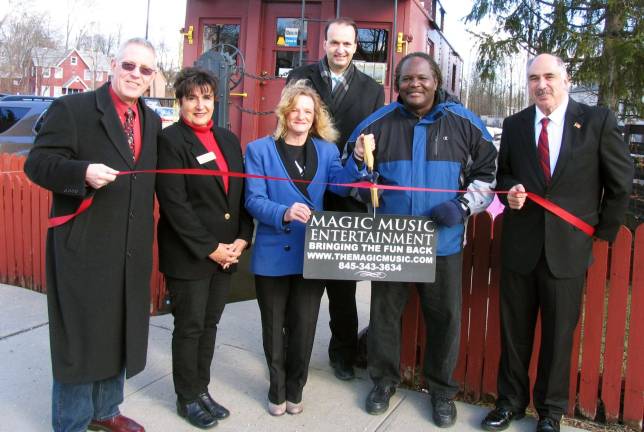Grand openings Photo by Roger Gavan Magic Music Entertainment celebrates expansion in Warwick market outside the Chamberís ìCabooseî office on South Street: From left, Michael Johndrow, executive director of the Warwick Valley Chamber of Commerce; Chamber First Vice President Sherry Bukovcan, Magic Music Public Relations Director Catherine Bailey, Chamber President Paul Rafanello, Magic Music owner Samuel Opher and Town of Warwick Deputy Supervisor James Gerstner.