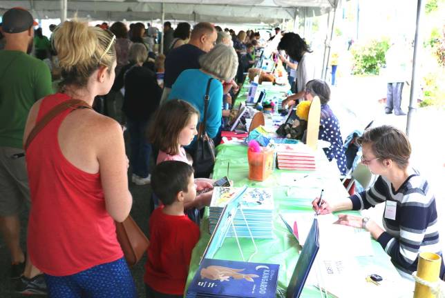 A book full of thanks Photo by Roger Gavan The sixth biennial Warwick Children’s Book Festival, held on Saturday, Oct. 7, on Railroad Avenue in the Village of Warwick, drew record crowds and by all accounts was a huge success: Children's Book Festival raised $7,000 for Albert Wisner Public Library.