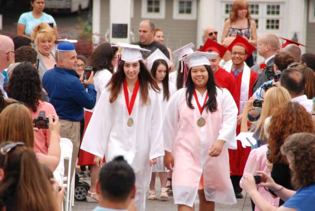 Cheers to the George F. Baker High School Class of 2015 Valedictorian Isabella Zaccardi and Salutatorian Kelly Chhe lead their classmates into the graduation ceremony.