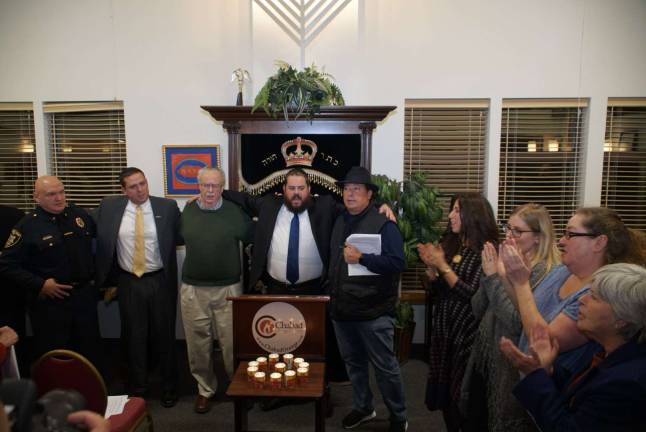 'How do we respond to baseless hatred? Wanton love' Community support and lighted candles at Sunday's healing services (Photo courtesy of Dr. Michael Hoffman)