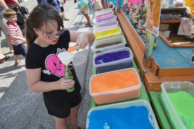 Celebrating community in Florida, NY This young girl is creating sand art.