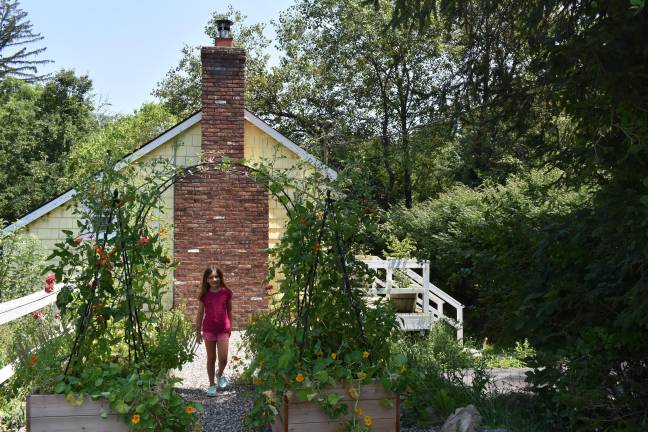 Local green thumbs harvest top honors A visitor checks out the Colon-Mariotti garden. This expanded raised bed portion was built over a former driveway. (Photo by Becca Tucker)