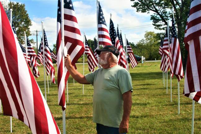 Michael Barry checks the name on a flag in the Flags for Heroes display on Route 94. Barry said he was looking for his son, Rev. Michael Barry, Jr. who served 21 years in the United States Air Force before retiring in 2011.