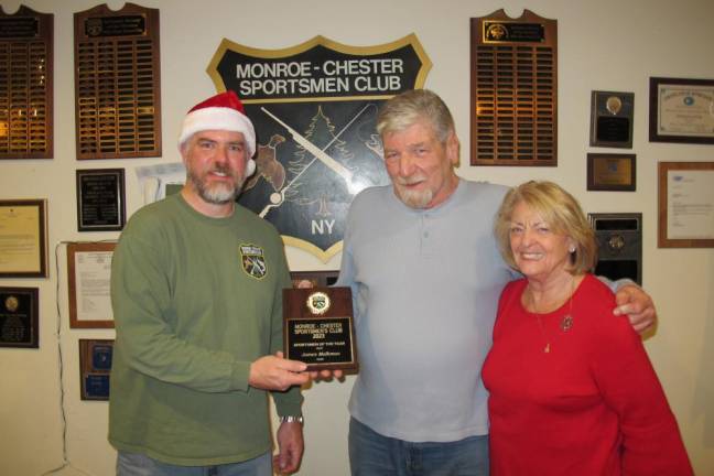 President Kevin Faith presents the Sportsman of the Year award to James Malkmus alongside Vice President Diane Bramich.