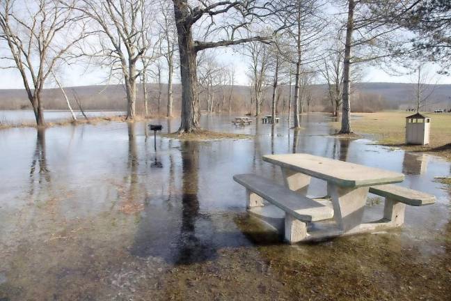 The Wickham Lake picnic area flooded and turned to ice on Sunday morning as streams and lakes were overflowing after heavy rains fell with melting snow on Christmas Day. Photo by Robert G. Breese.