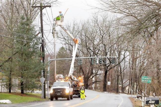 Warwick. Christmas morning storm A crew from Orange and Rockland Utilities, Inc., repair a utility pole that caught fire at the corner of Blooms Corners Road and County Route 1.