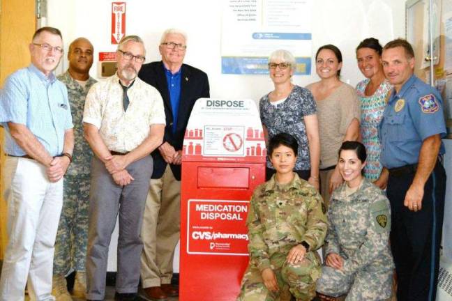 New medication disposal unit at Warwick Police Department well received Photo provided by Jennifer O'Connor Attending the presentation of the new Drug Collection Unit at the Warwick Police Department are: Kneeling, from left, NY National Guard SPC Jooby Jimenez and SGT Carissa Lombardo; Standing, from left, Town of Warwick Supervisor Michael Sweeton; SSG Wyndollyn Patino, Mayor Michael Newhard; Orange County Legislator and Deputy Mayor Barry Cheney; Annie Colonna, director of Prevention Services at the Warwick Valley Community Center; Lacey Benjamin of the Mid-Hudson Prevention Resource Center; Lauren Savino of the Alcoholism and Drug Abuse Council; and Warwick Police Lt. John Rader.