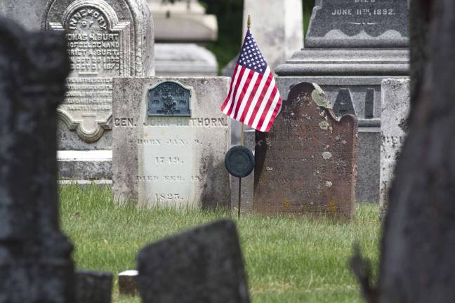 Photo by Robert G. Breese Every year for Memorial Day the boy scouts place an American flag at the grave site of General John Hathorn who was a Warwick resident and served in the Revolutionary War. He is buried next to his wife in the Warwick Cemetery; her stone is on the right.