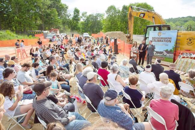 Orange County Executive Steve Neuhaus, with Rabbi Pesach and Chana Burston at his side, addresses the crowd at the Chabad Campus Groundbreaking Celebration.