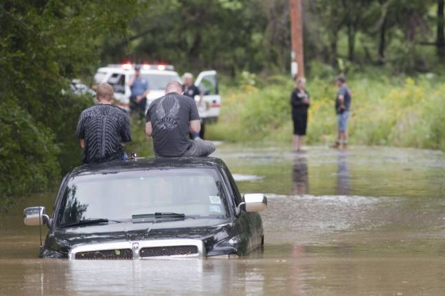 Flooding: The good, the bad, and the ugly Photo by Robert G. Breese Two men sit stranded on their pickup on Blooms Corners Road last summer as the Wawayanda Creek surrounds them, and responders from Warwick and Pine Island try to figure out the best way to reach them.