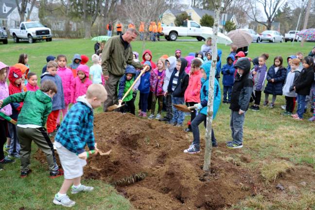 Village of Warwick celebrates Arbor Day at Stanley-Deming Park Several children were invited to take turns shoveling some dirt to help plant the new tree.