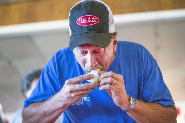 The sweet taste of victory Photo by Robert G. Breese Winner Raymond Wesolowski of Westtown eats a Black Dirt onion during the annual Pine Island Chamber of Commerce onion eating contest at the Pine Island Summerfest last weekend.