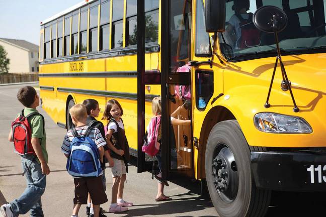 School district buying 6 new buses following deadly crash Elementary school students get on school bus