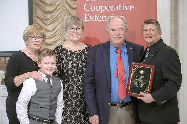Dr. Paul Johnson awards Michael R. Pillmeier the Cornell Cooperative Entension's 2019 Distinguished Service Award. Pictured from left to right are: Ronan, Marie Pillmeier, Maire Ullrich, Michael R. Pillmeier and Dr. Paul Johnson.