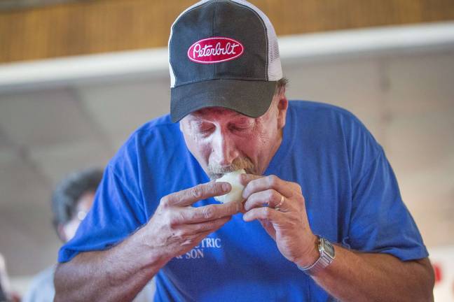 Onion eating contest set for Sept. 1 Winner Raymond Wesolowski of Westtown eats a black dirt onion during the annual Pine Island Chamber of Commerce onion eating contest at the Pine Island Summerfest at 6:00 PM Saturday August 18, 2012.