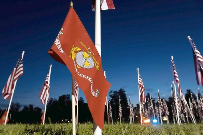 Thirteen additional American flags have been added to the Flags For Heroes in Warwick as a tribute to the military personnel lost during the Kabul, Afghanistan, airlift. The flags form a circle and are marked with United States Marine Corps, Navy and Army flags representing the branch of service each of those who died. Photo by Robert G. Breese.