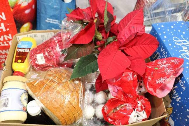 Warwick Ecumenical Food Pantry distributes more than 200 Christmas food baskets Photos by Roger Gavan Donors prepared attractive Christmas baskets fir their "adopted" families.