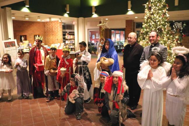 Spanish Mass at St. Stephen's held to celebrate El Dia De Reyes, the Epiphany After the service Pastor Rev. Jack Arlotta (left) and Rev. Richard Marrano and the children posed for any parents who wished to take photographs.