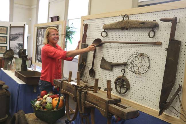 Agricultural exhibit now open at Warwick Historical Society Buckbee Center Photo by Roger Gavan Warwick Historical Society Executive Director Lisa Weisbrod points to some of the essential farming implements of yesteryear.