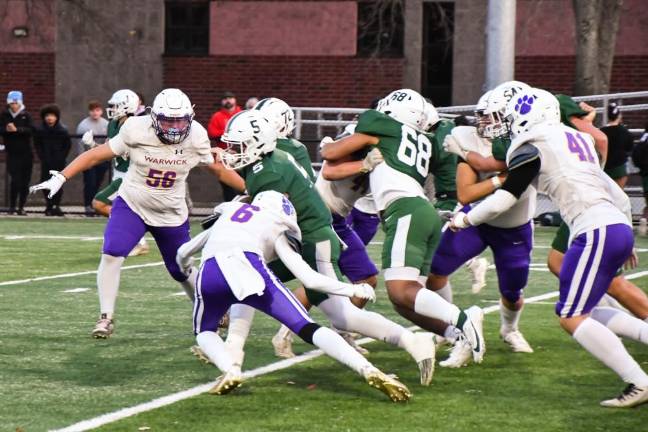 Warwick’s Nick Sirico (#6), Grant Havell (#56) and Wyatt Vreeland (#41) converge on Cornwall’s running back in the Section IX Class A Semifinal. Cornwall defeated the Wildcats and will move on to the championship this weekend.